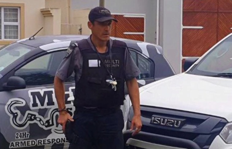 Multi Security response officer beside a company vehicle